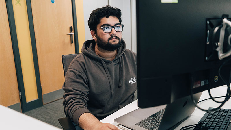 A Student Ambassador looking at a computer